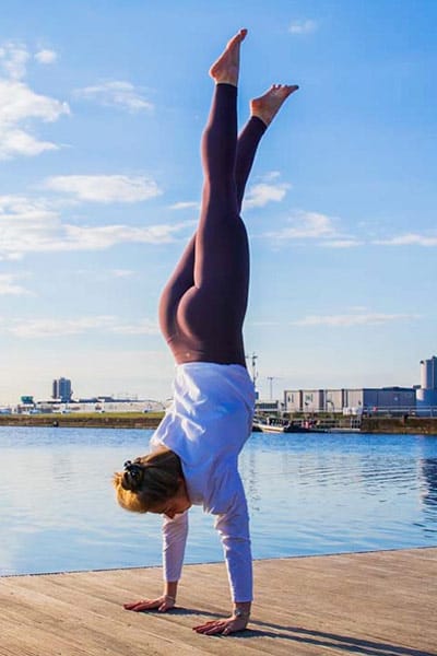yoga teacher in a handstand
