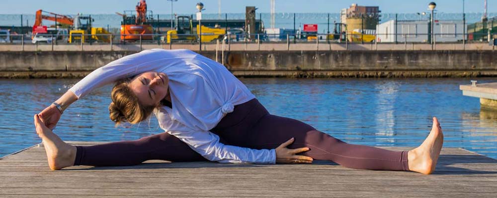 Yoga teacher stretching